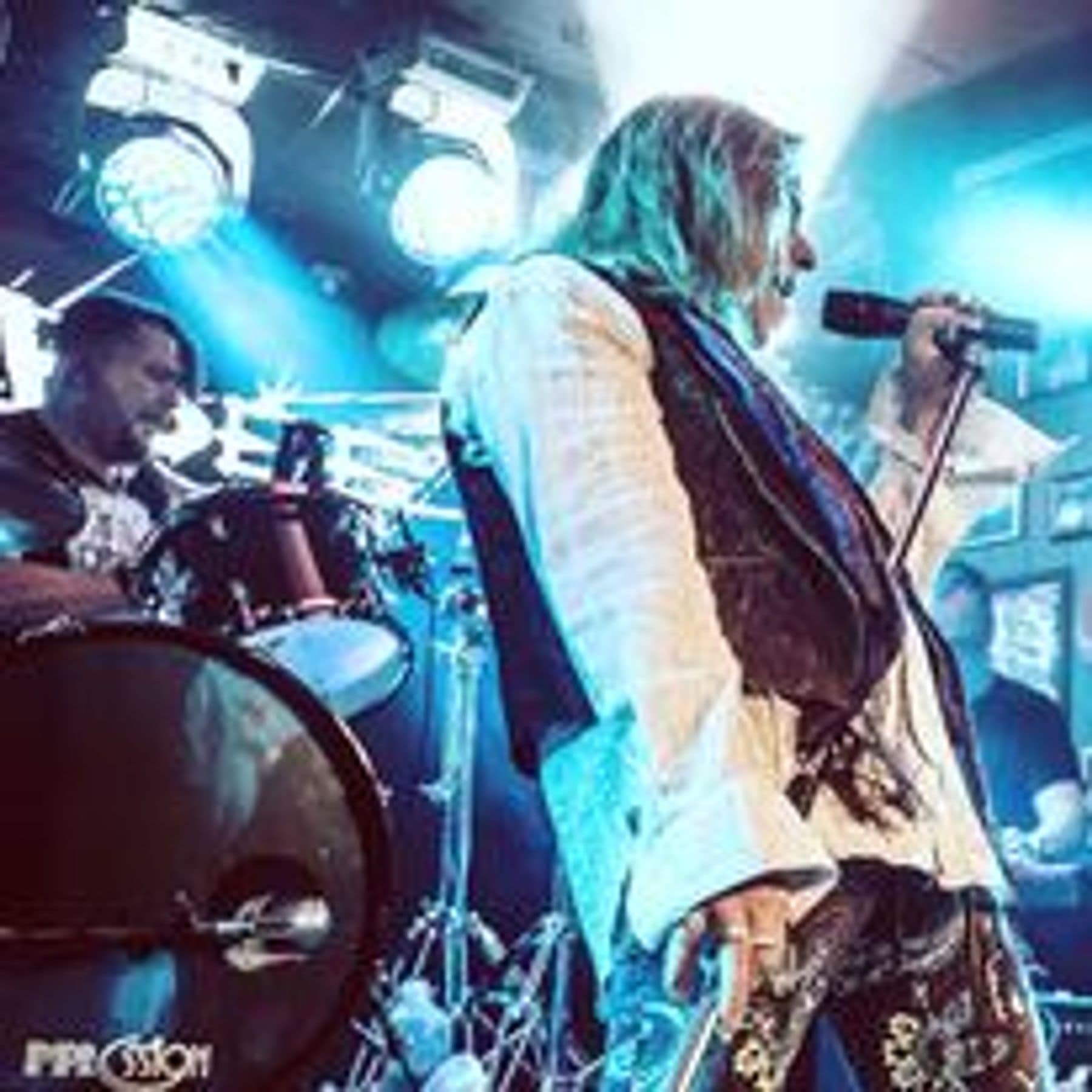 Brian Bee Frank on stage in blue light with Killer Bee